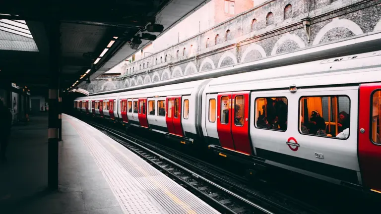 London Underground train standing at a platform during a bright daytime service