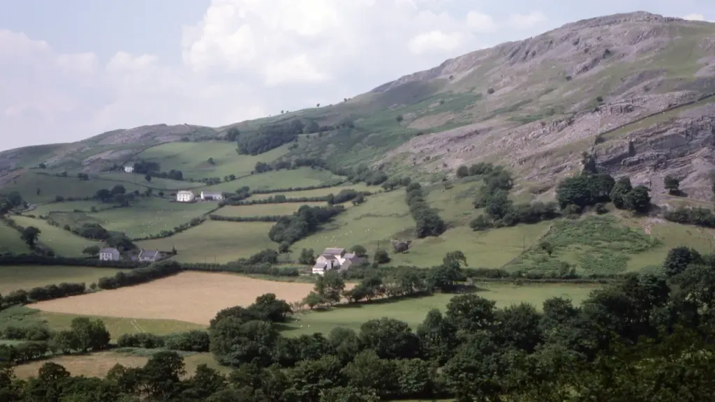 Lush green hillside of the Black Mountains in the Welsh countryside with farmsteads.