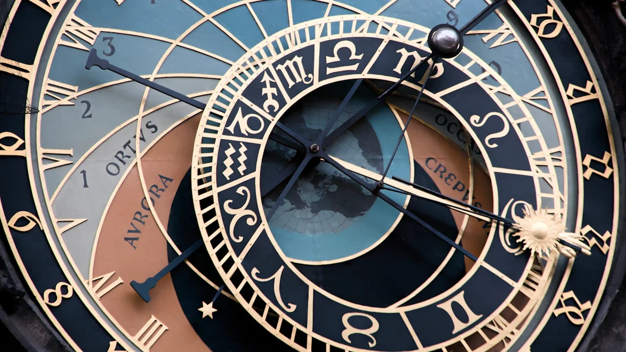Close-up detail of the historical Prague Astronomical Clock face featuring intricate zodiac symbols.