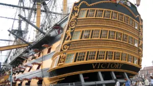 The stern of HMS Victory in dry dock, reflecting its historic naval heritage.