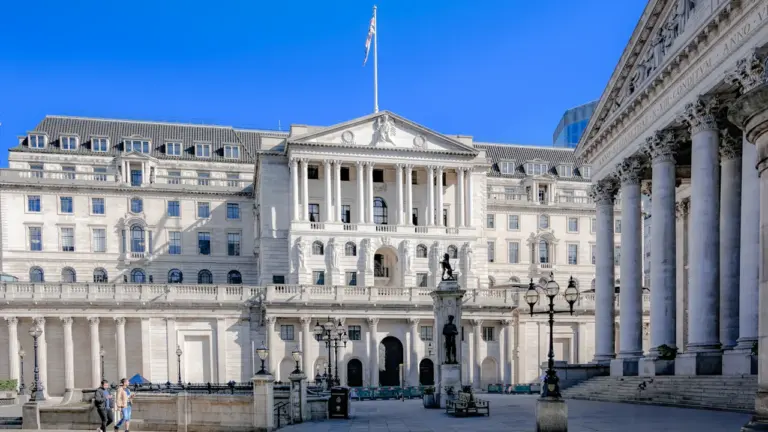 The iconic Bank of England building facade featuring classical pillars in the City of London.